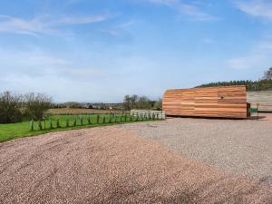 a wooden building sitting on top of a gravel road at Squirrels Retreat - Uk46127 in Nesscliffe +8 photos