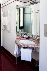 a bathroom with a sink and a large mirror at Residenza Mecenate in Rome +16 photos