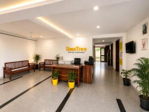 an office with a desk and two benches and plants at Lime Tree Hotel Golf Course Extension Nearby Grand Hyatt Gurgaon in Gurgaon