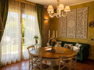a dining room with a table with chairs and a chandelier at La Mammola Bed&Breakfast in Fabriano