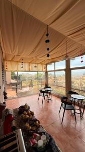 a kitchen with tables and chairs and a tent at Montecielo in San Antonio de Arredondo