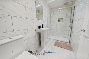 a white bathroom with a sink and a shower at AltoHaus Luxury 4BR House By AltoLuxo Short Lets & Serviced Accommodation With Parking in Bristol