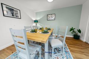 a dining room with a wooden table and chairs at AltoHaus Luxury 4BR House By AltoLuxo Short Lets & Serviced Accommodation With Parking in Bristol