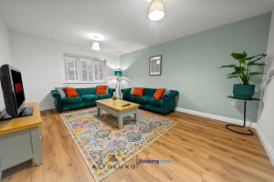 a living room with a couch and a table at AltoHaus Luxury 4BR House By AltoLuxo Short Lets & Serviced Accommodation With Parking in Bristol
