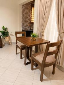 a wooden table and chairs in a living room at Ecostar apartments in Morogoro