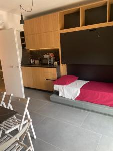 a bedroom with a bed with a red and white blanket at Fra Rooms in Taormina +11 photos
