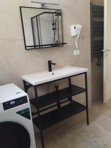 a bathroom with a sink and a mirror at Country House Villa Marezi in Cupra Marittima +39 photos