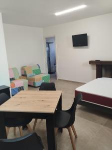 a room with a bed and a table and chairs at Country House Villa Marezi in Cupra Marittima