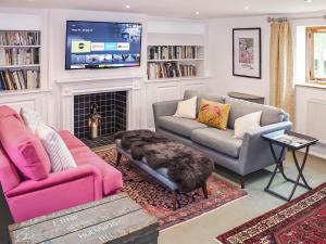 a living room with two couches and a tv at The Granary - Uk52147 in Brundall