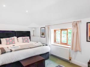 a bedroom with a large bed and a window at The Granary - Uk52147 in Brundall