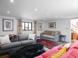 a living room with two couches and a pink couch at The Granary - Uk52147 in Brundall