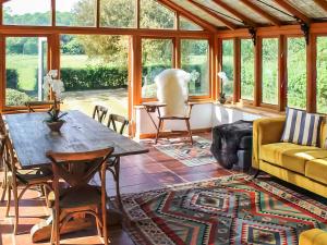a living room with a table and a couch at The Granary - Uk52147 in Brundall