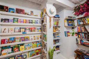 a book shelf filled with books in a room at Pousada Vila DuJu in Porto De Galinhas