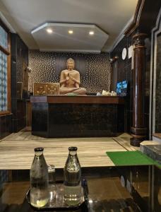 a room with a statue of a man on the wall at HoTEL SVR ELITE in Vijayawāda