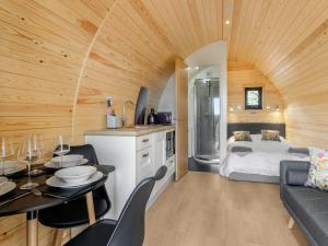 a room with a bed and a table and a kitchen at Rabbits Rest - Uk46128 in Nesscliffe