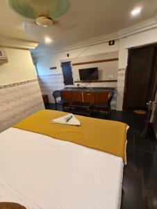 a hotel room with a bed and a dining room at HoTEL SVR ELITE in Vijayawāda