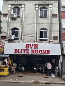 a building with a sign that reads sy elite rooms at HoTEL SVR ELITE in Vijayawāda