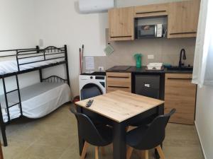 a small kitchen with a table and a bunk bed at Country House Villa Marezi in Cupra Marittima