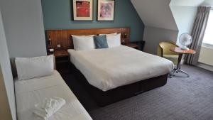 a hotel room with a bed and a chair at Best Western Ship Hotel in Weybridge +47 photos