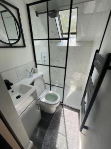 a small bathroom with a toilet and a sink at Plgs and Blankets in Pucklechurch