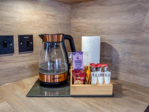 a blender sitting on a counter next to a box of food at The Pines in Aviemore