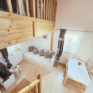 a living room with a white couch and wooden ceilings at FeWo Mangfall in Bruckmühl