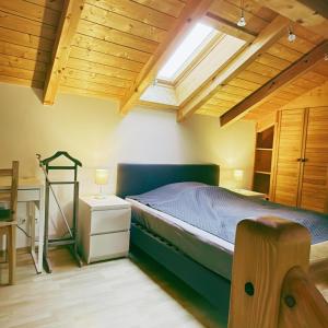 a bedroom with a bed and a wooden ceiling at FeWo Mangfall in Bruckmühl