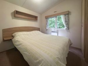 a bedroom with a bed and a window at Mallard - Uk52121 in Hevingham