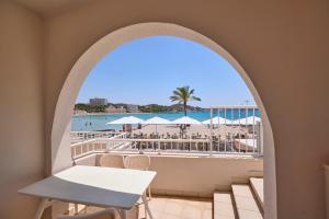a view of the beach from the balcony of a resort at INNER Niza Paguera in Paguera