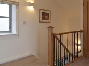 a staircase in a home with a window and a stair case at Five Barred Gate Barn in Inglewhite