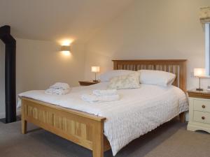 a bedroom with a bed with two towels on it at Five Barred Gate Barn in Inglewhite +11 photos
