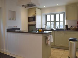 a kitchen with a counter top and a sink at Five Barred Gate Barn in Inglewhite