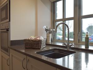 a kitchen counter with a sink and a window at Five Barred Gate Barn in Inglewhite