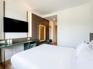 a hotel room with a bed and a flat screen tv at B&B HOTEL Ascoli Piceno in Ascoli Piceno +29 photos