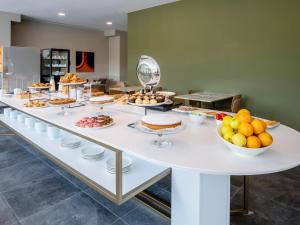 a buffet of food on a white table at B&B HOTEL Ascoli Piceno in Ascoli Piceno