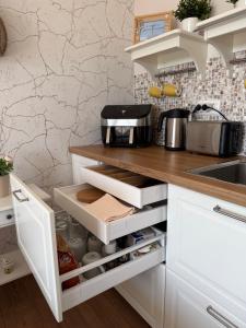 a kitchen with white cabinets and a counter top at Blaxy del Mar Studio Olimp in Olimp