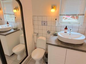 a bathroom with two toilets and a sink at Studio Next to CPH Airport with Outdoor Space in Copenhagen