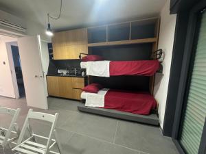 a room with a bunk bed with red and white blankets at Fra Rooms in Taormina