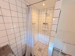 a shower with a shower curtain in a bathroom at Studio Next to CPH Airport with Outdoor Space in Copenhagen