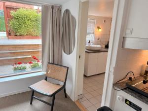 a kitchen with a chair next to a window at Studio Next to CPH Airport with Outdoor Space in Copenhagen +27 photos