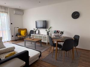 a living room with a couch and a table at Radnóti Apartman Győr in Győr