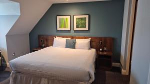 a bedroom with a large white bed in a room at Best Western Ship Hotel in Weybridge