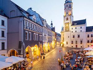 a city street with a clock tower and a building at Ferienwohnung Villa Bismarck mit Sauna und Whirlpool in Görlitz