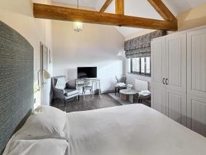 a bedroom with a bed and a living room at Valentines Cottage - Uk48509 in Kirk Hammerton