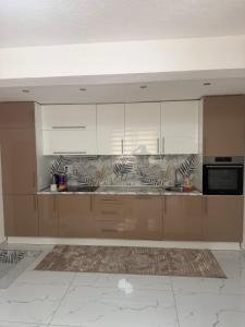 a large kitchen with white cabinets and appliances at Luxury Apartments Sarajevo in Ilijaš