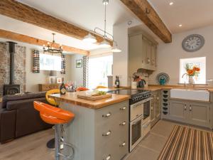a kitchen with an island in the middle of a room at The Barn - Uk2475 in West Witton +14 photos