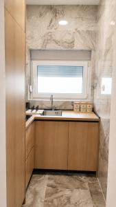 a kitchen with a sink and a window at Two Palms Apartment in Sutomore +44 photos