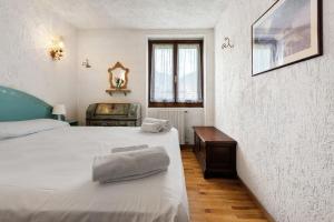 a bedroom with a bed with two towels on it at Dolomiti Apartment Pinzolo in Pinzolo