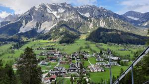 a village in a valley with mountains in the background at Obergrabnerhof in Ramsau am Dachstein