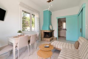 a living room with a table and a fireplace at A casa d'Irene in Amalias